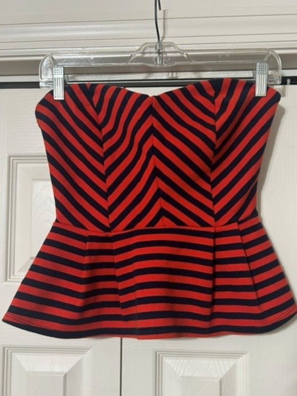 Forever 21 strapless peplum top features a bold red and navy blue striped.(M)